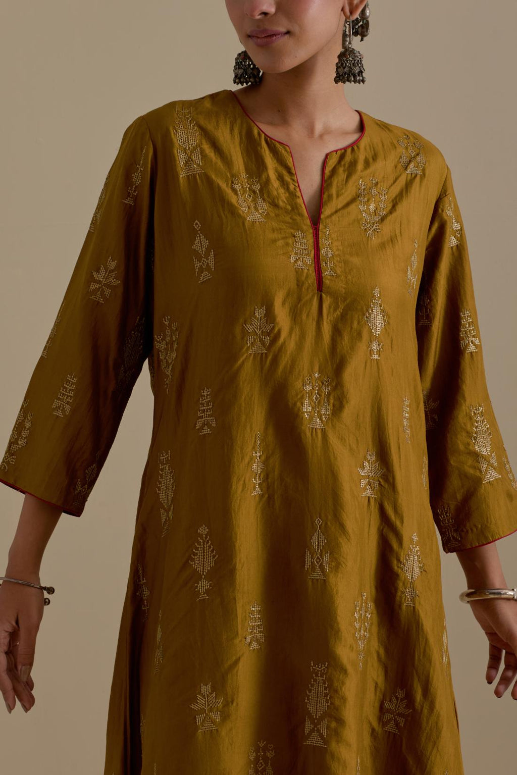 Olive silk straight long kurta set, highlighted with dull gold zari and sequins handwork.