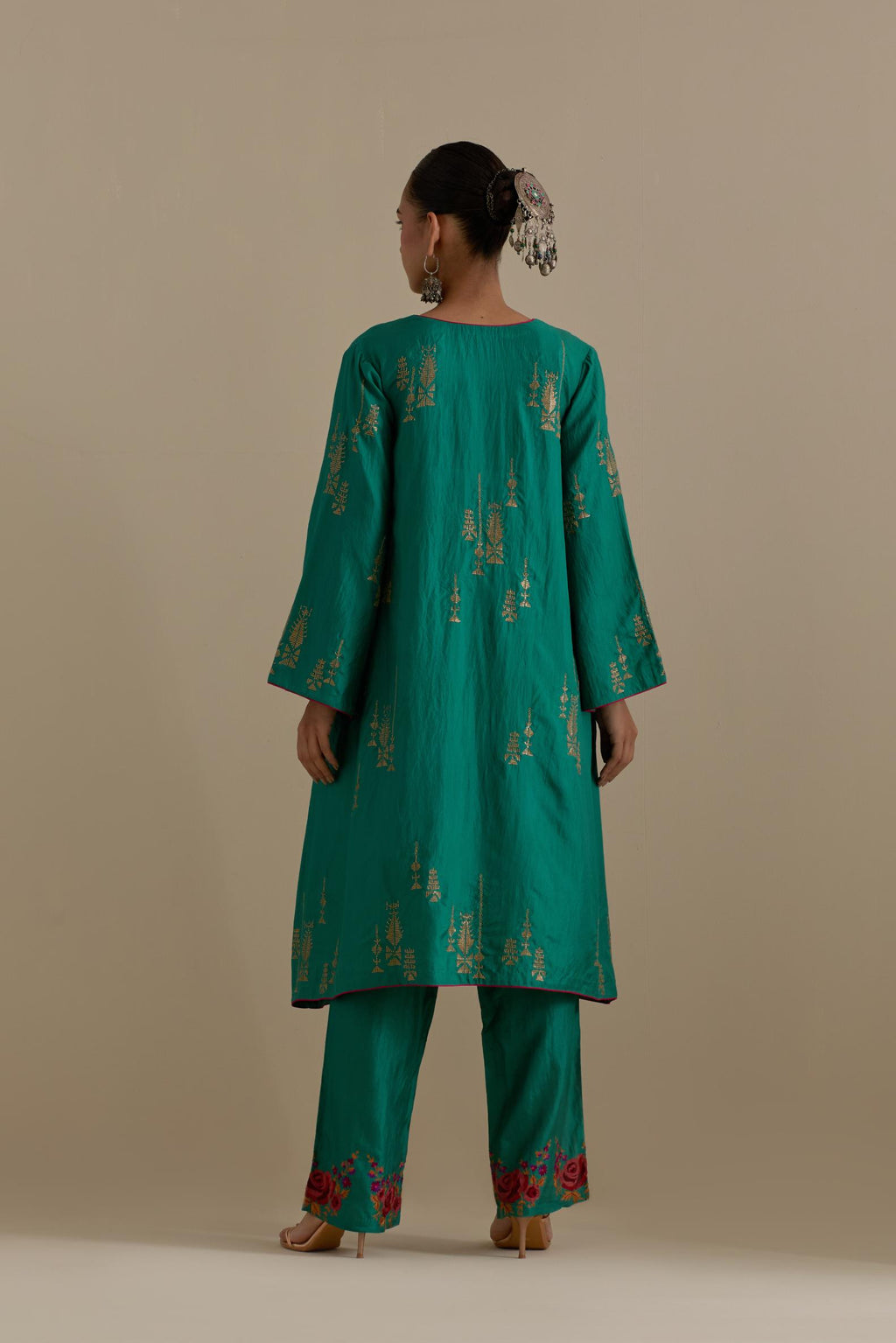 Persian green silk A-line short kurta set, highlighted with dull gold zari and sequins handwork.