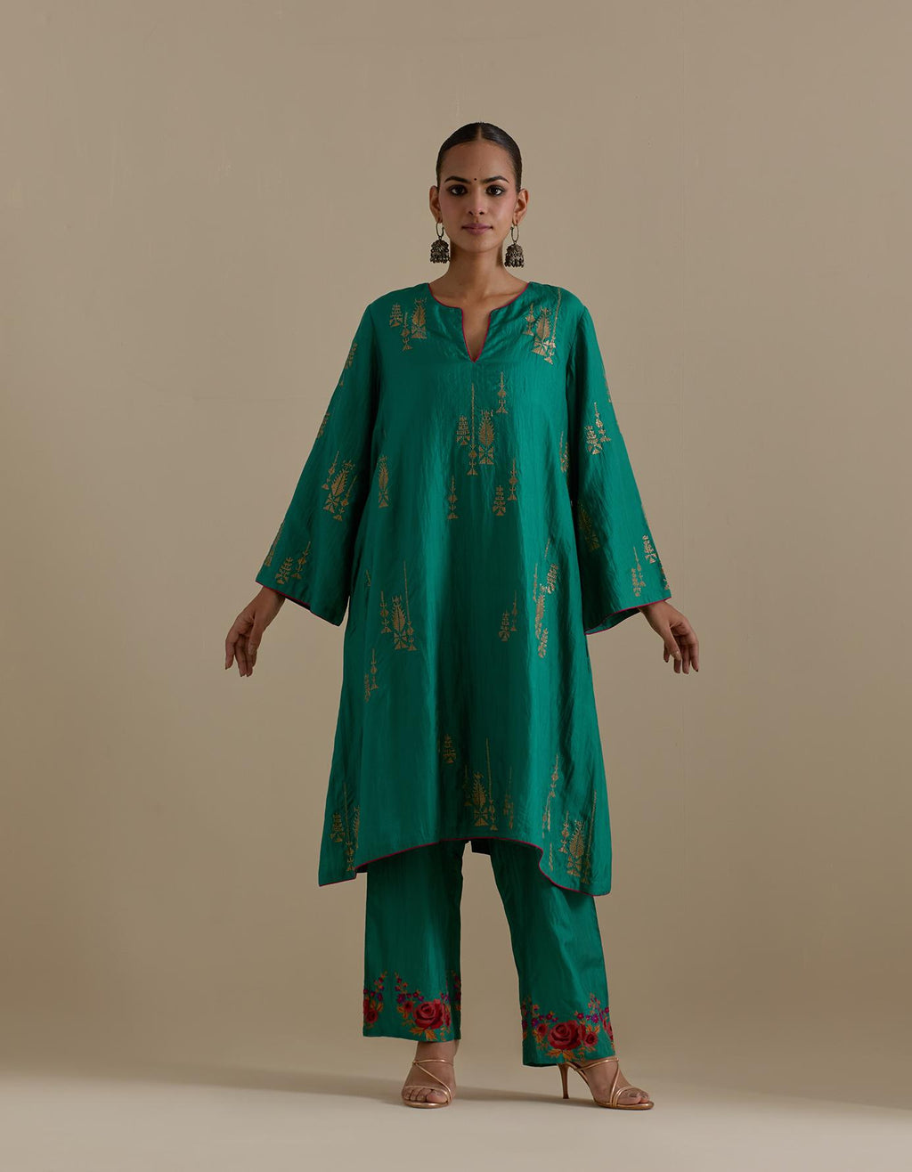 Persian green silk A-line short kurta set, highlighted with dull gold zari and sequins handwork.