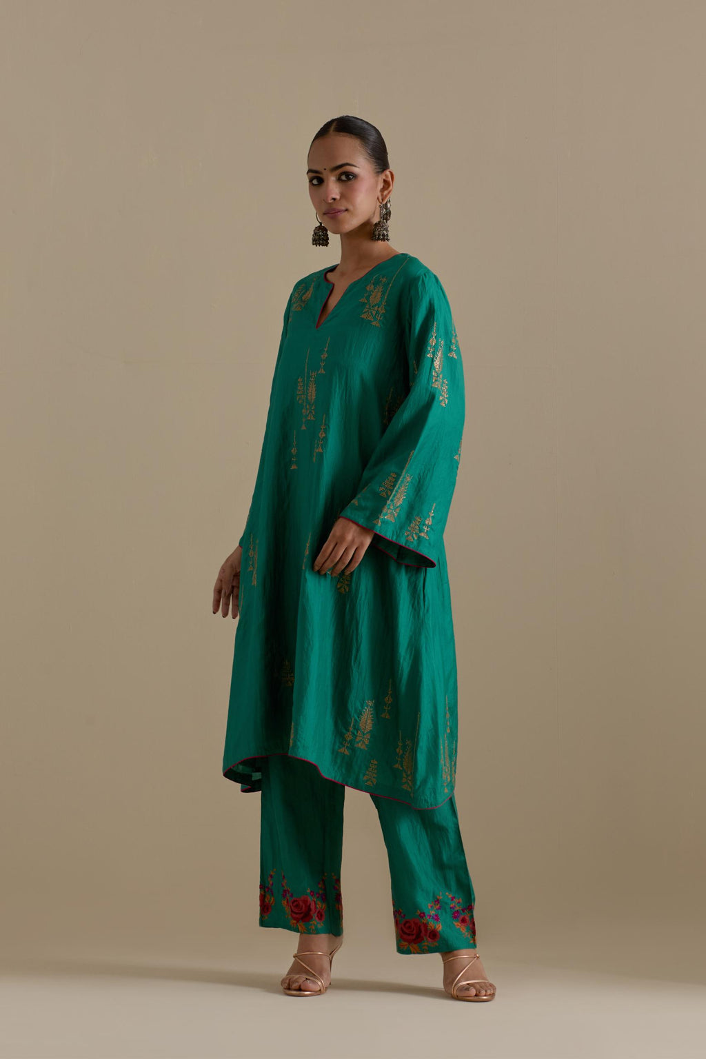 Persian green silk A-line short kurta set, highlighted with dull gold zari and sequins handwork.