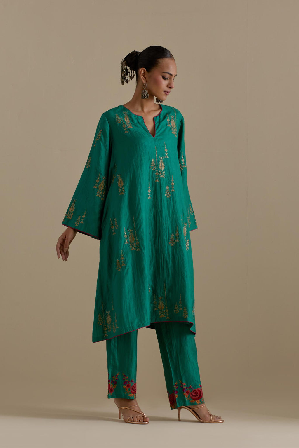 Persian green silk A-line short kurta set, highlighted with dull gold zari and sequins handwork.