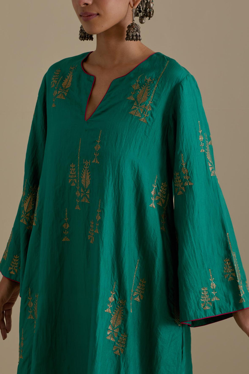 Persian green silk A-line short kurta set, highlighted with dull gold zari and sequins handwork.