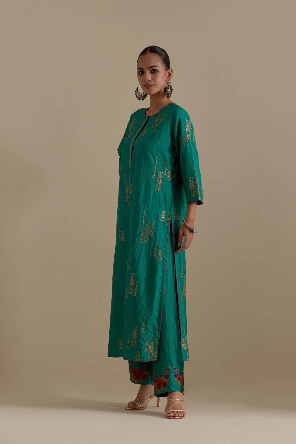 Persian green silk straight kurta set, highlighted with dull gold zari and sequins handwork.