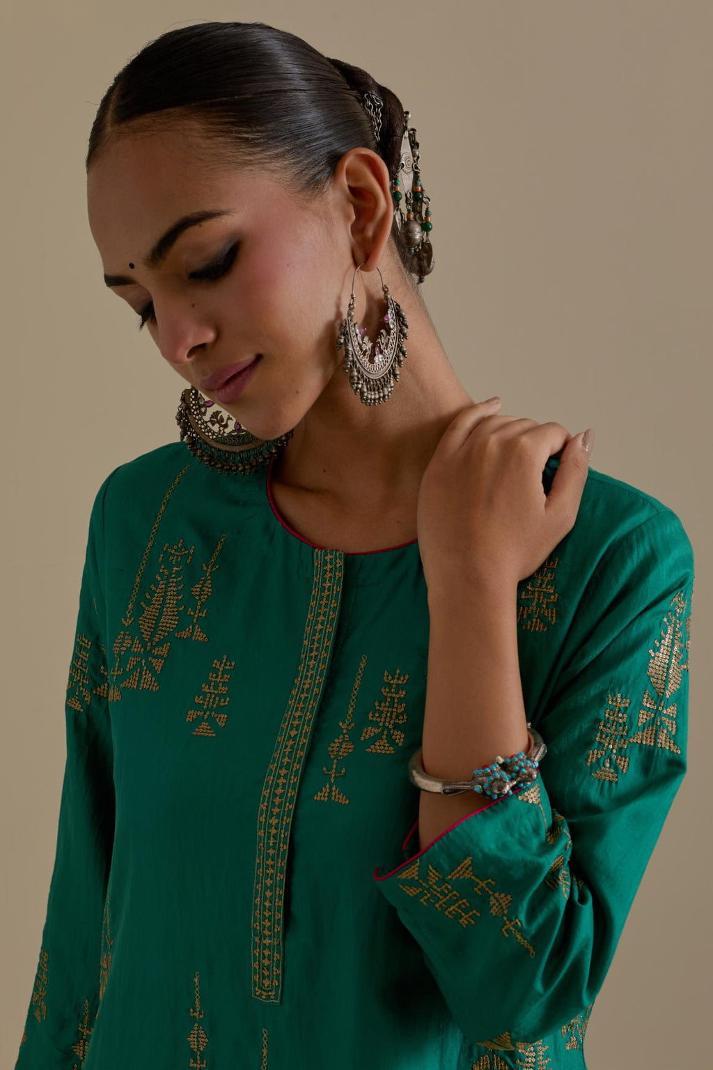 Persian green silk straight kurta set, highlighted with dull gold zari and sequins handwork.