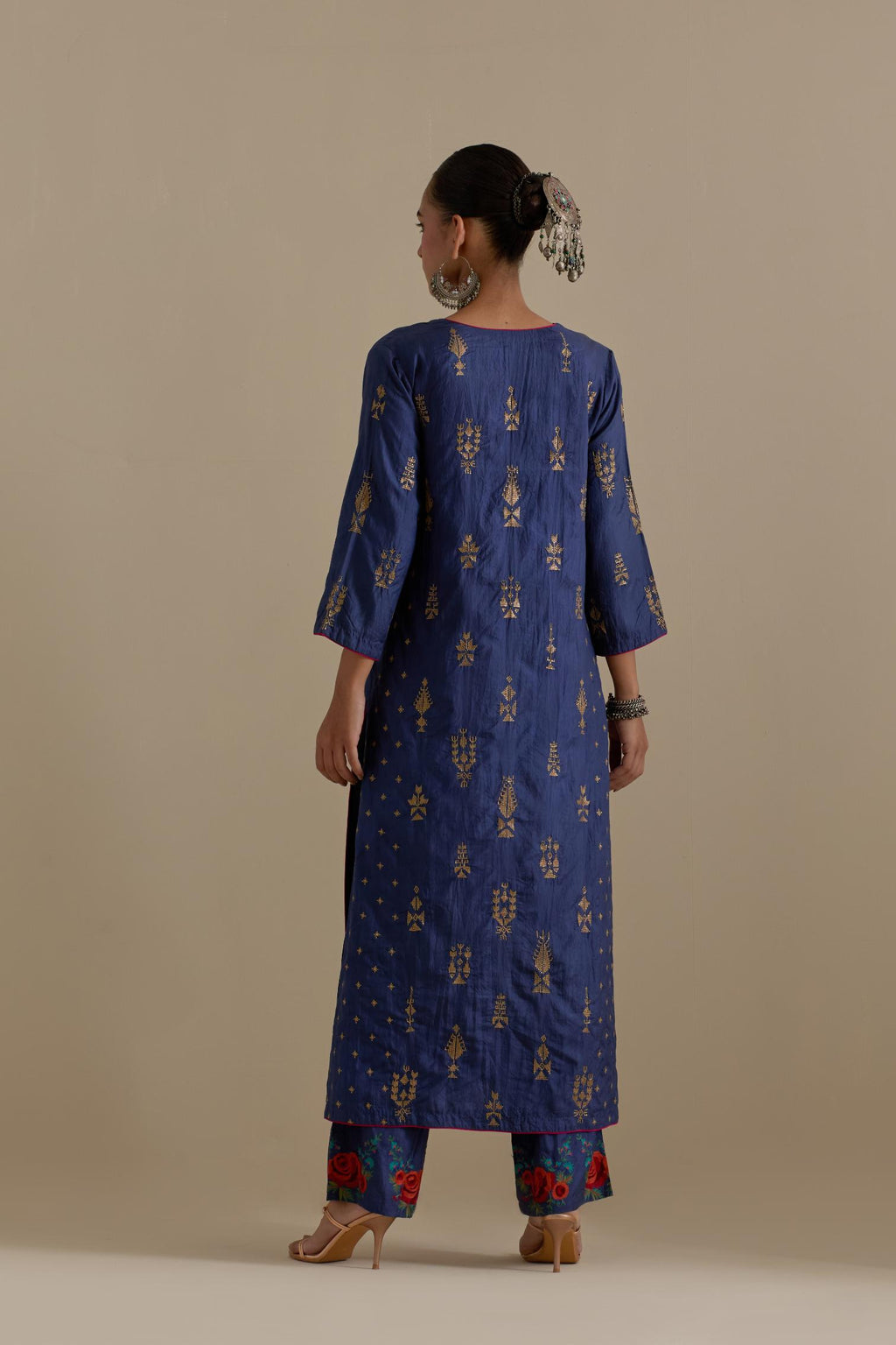 Blue silk straight kurta set with side panels, highlighted with dull gold zari and sequins handwork.