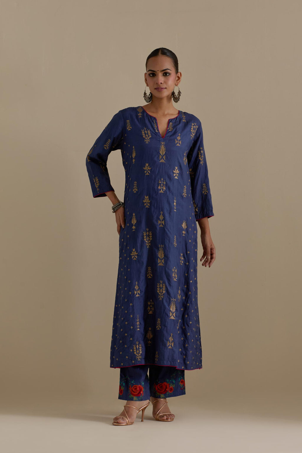 Blue silk straight kurta set with side panels, highlighted with dull gold zari and sequins handwork.