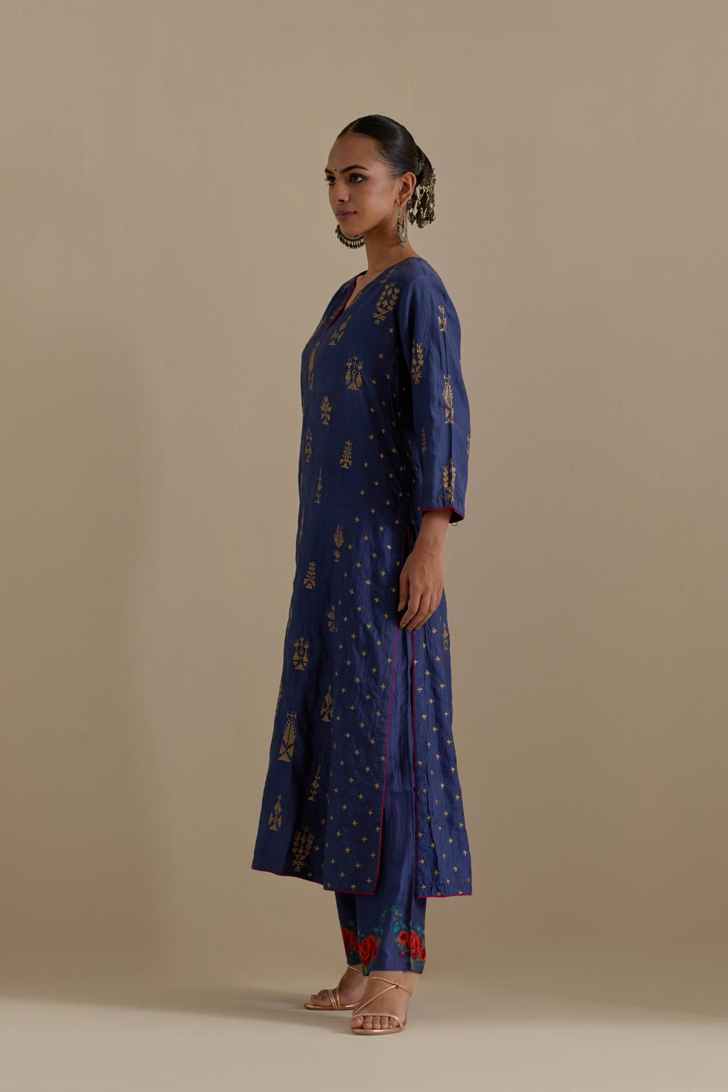 Blue silk straight kurta set with side panels, highlighted with dull gold zari and sequins handwork.