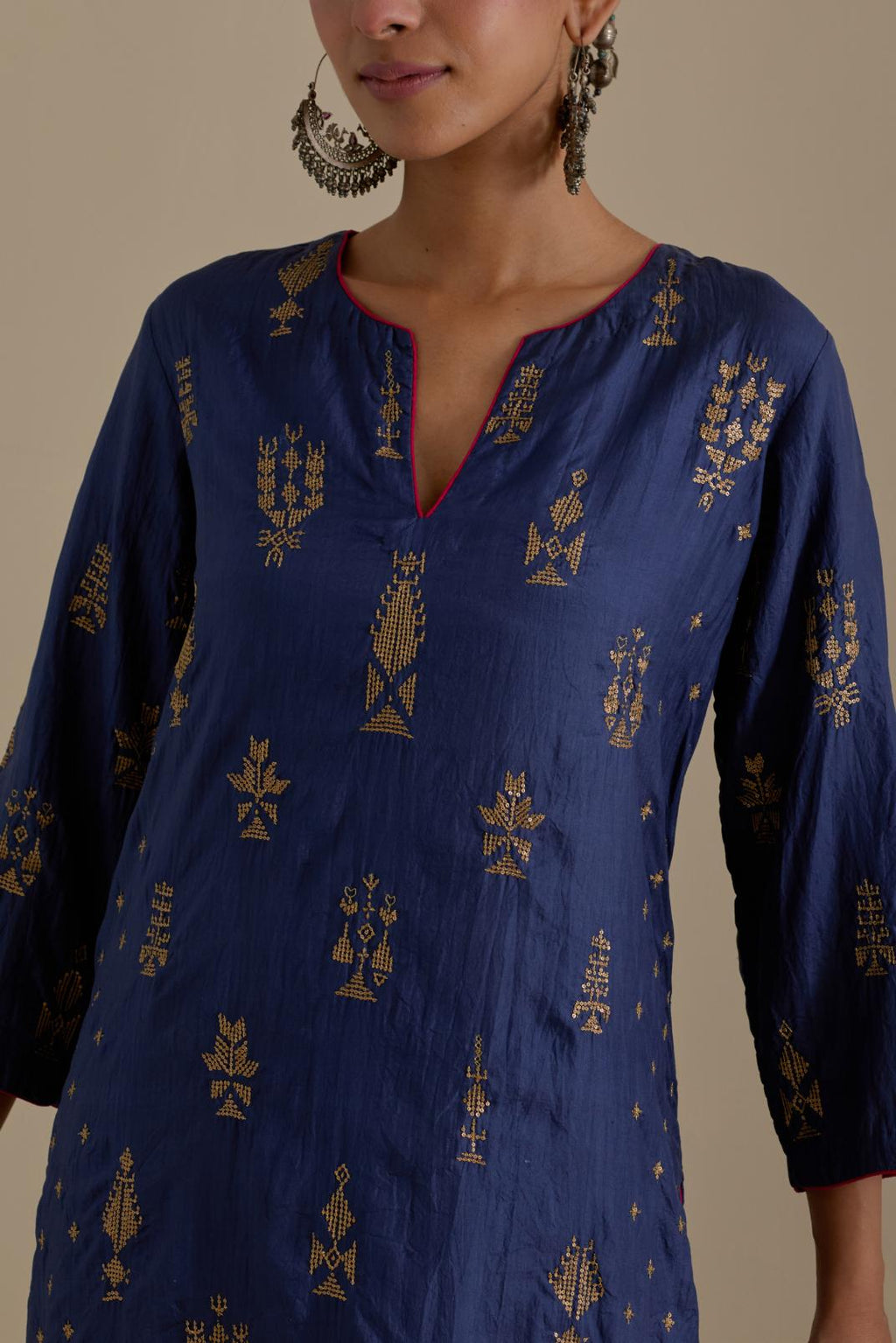 Blue silk straight kurta set with side panels, highlighted with dull gold zari and sequins handwork.