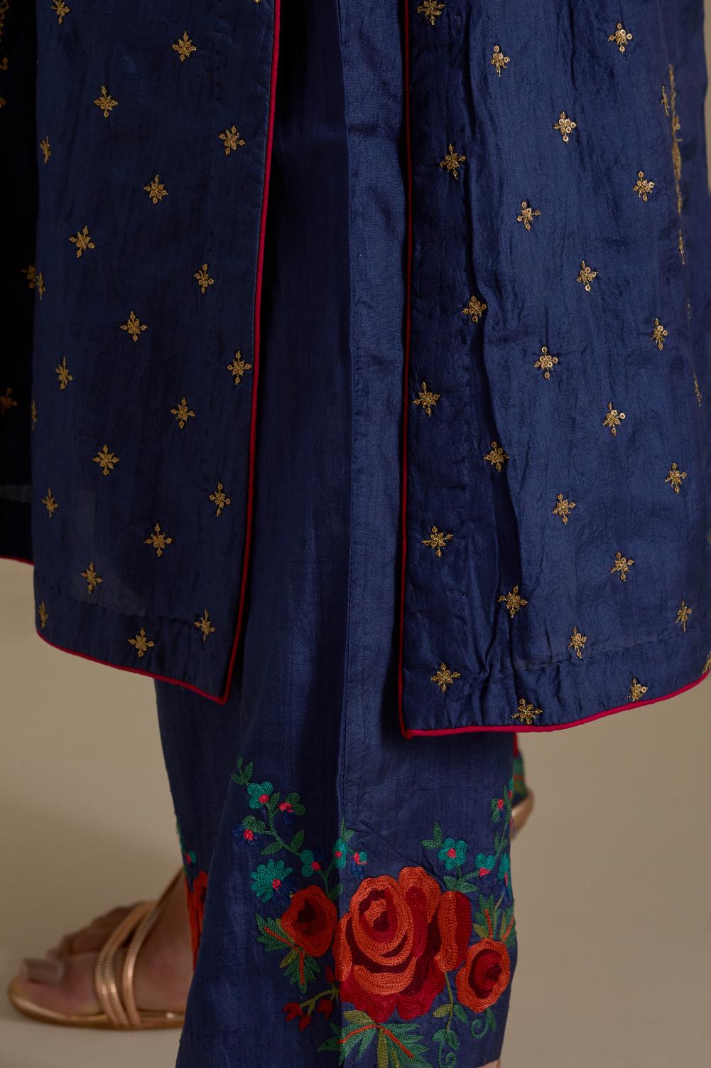 Blue silk straight kurta set with side panels, highlighted with dull gold zari and sequins handwork.