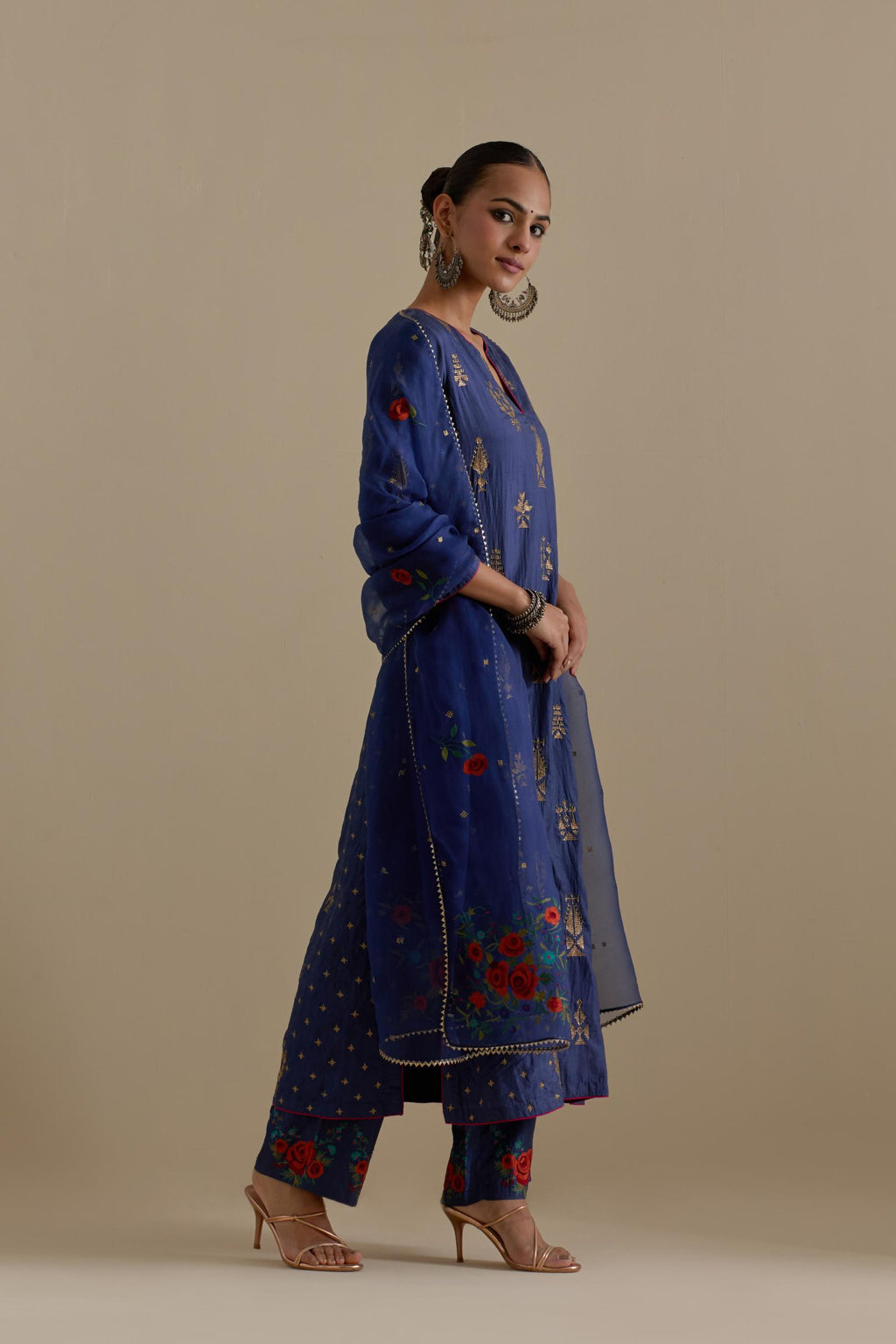 Blue silk straight kurta set with side panels, highlighted with dull gold zari and sequins handwork.