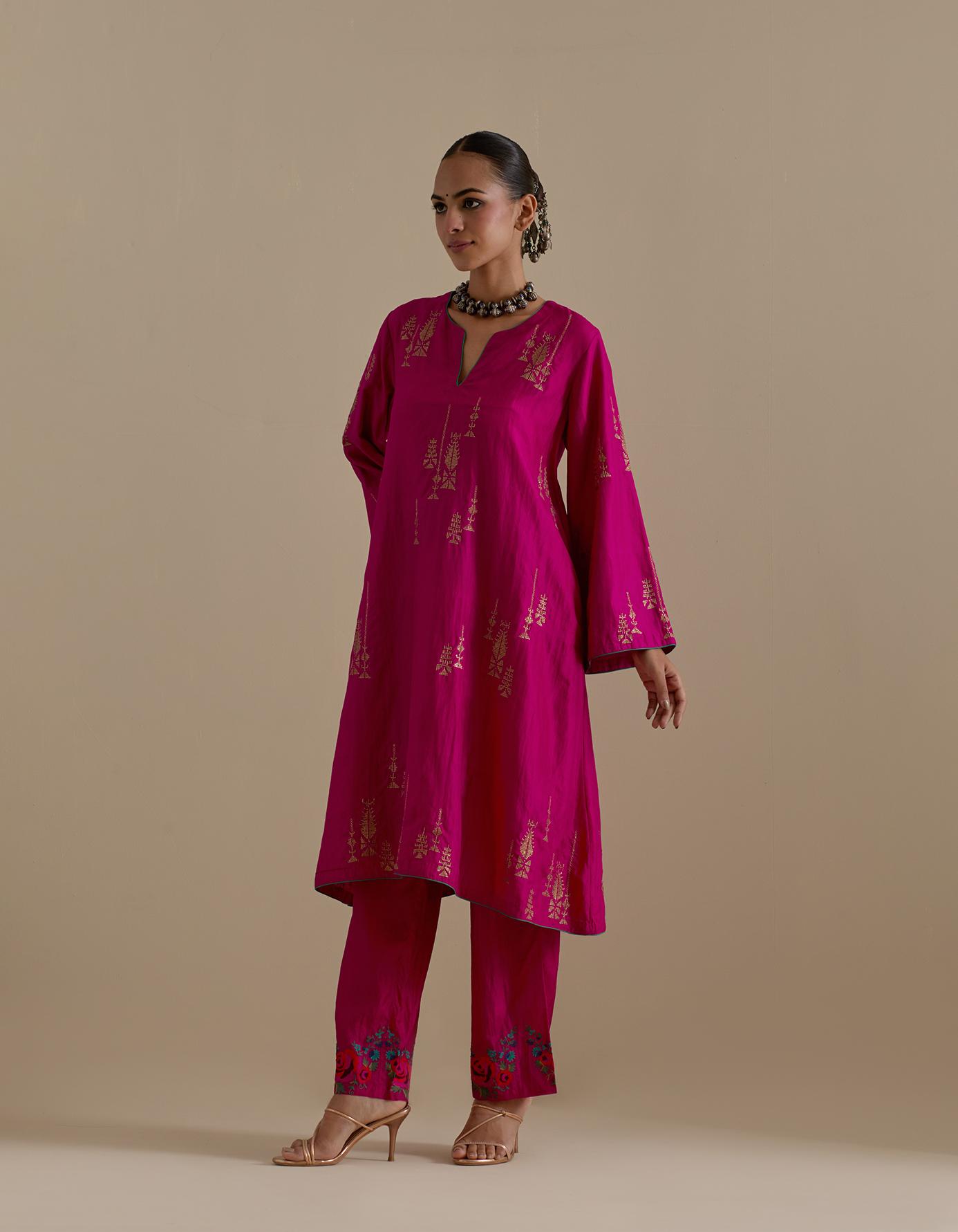 Fuchsia silk A-line short kurta set, highlighted with dull gold zari and sequins handwork.