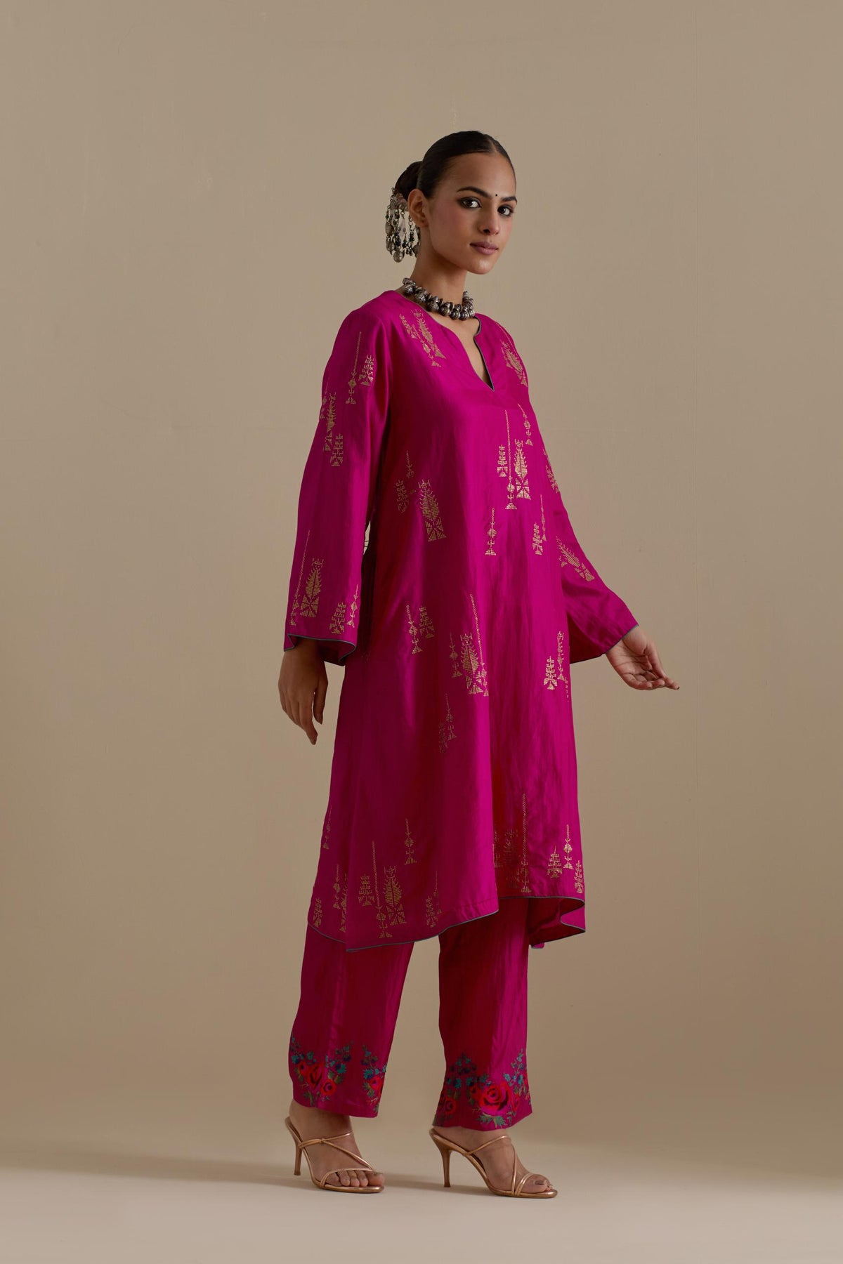 Fuchsia silk A-line short kurta set, highlighted with dull gold zari and sequins handwork.
