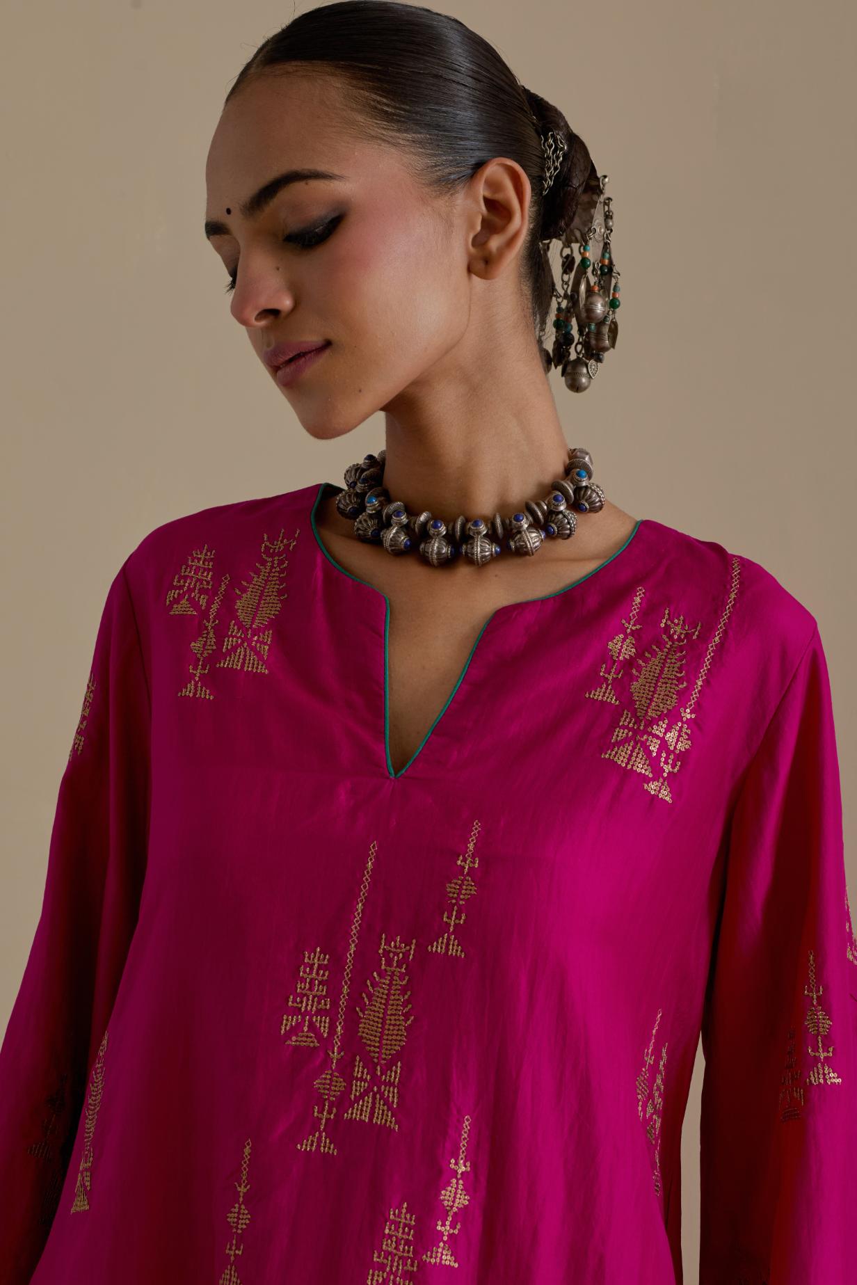 Fuchsia silk A-line short kurta set, highlighted with dull gold zari and sequins handwork.