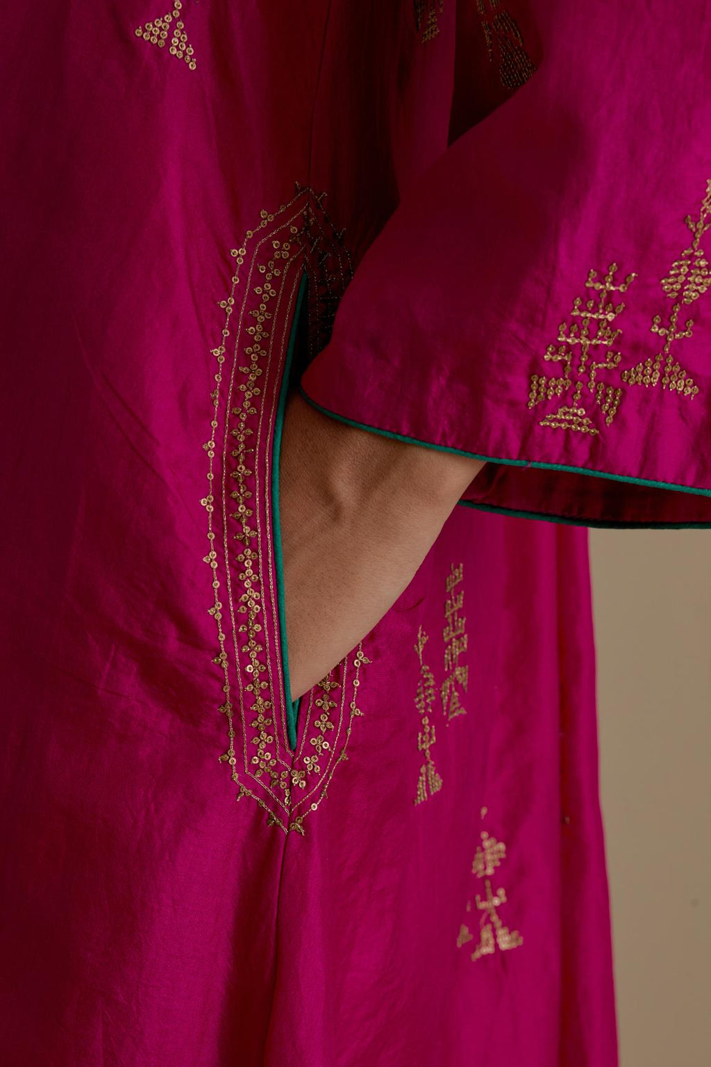 Fuchsia silk A-line short kurta set, highlighted with dull gold zari and sequins handwork.
