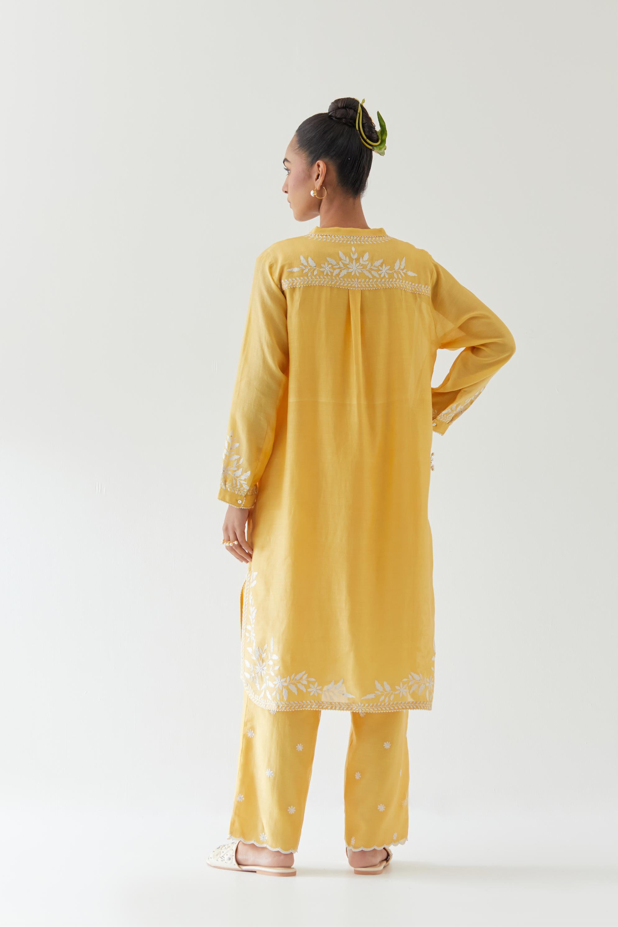 Yellow silk chanderi straight short kurta set with off white thread embroidery.