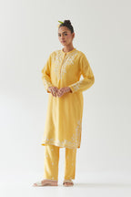 Yellow silk chanderi straight short kurta set with off white thread embroidery.