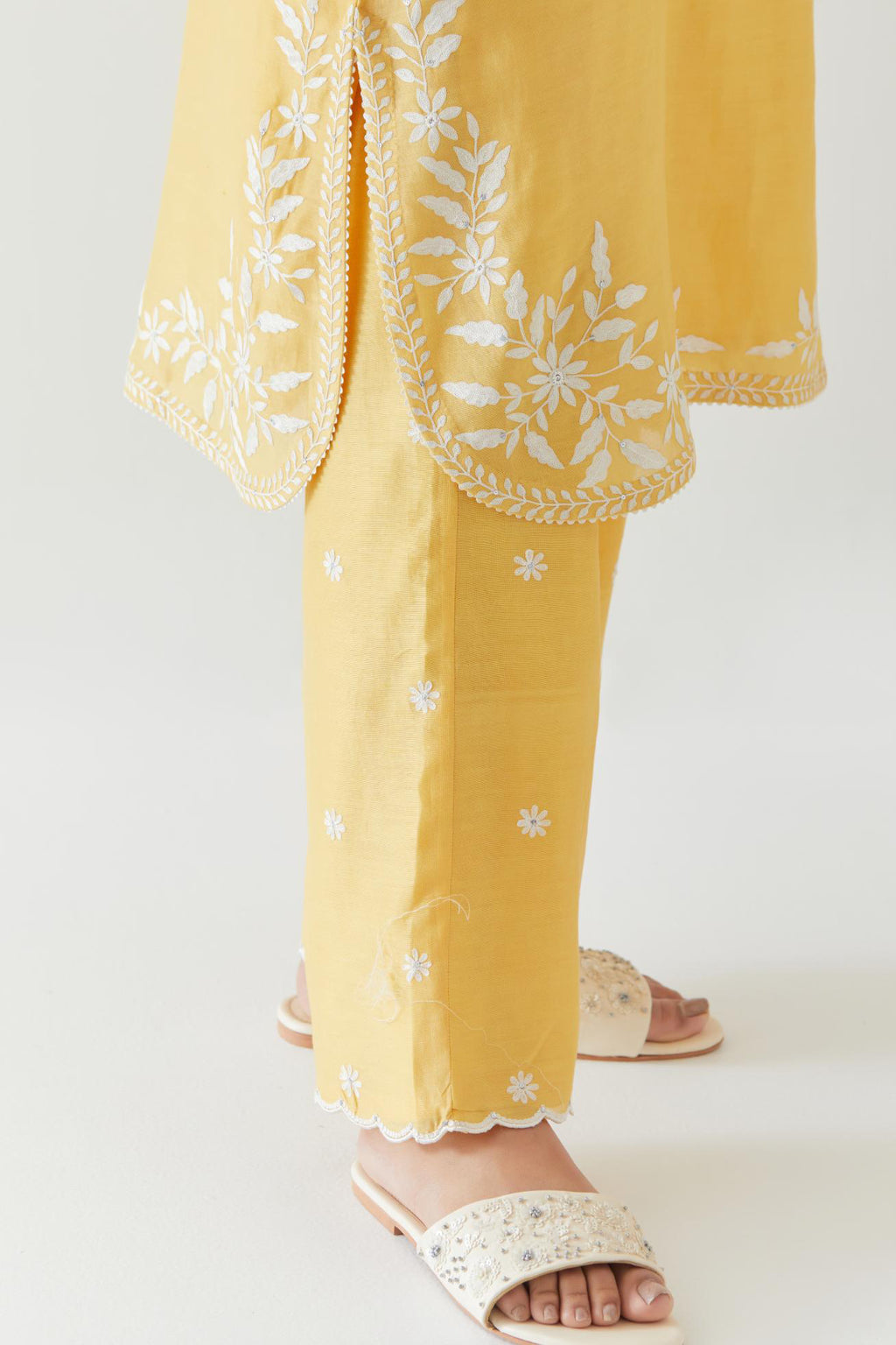 Yellow silk chanderi straight short kurta set with off white thread embroidery.