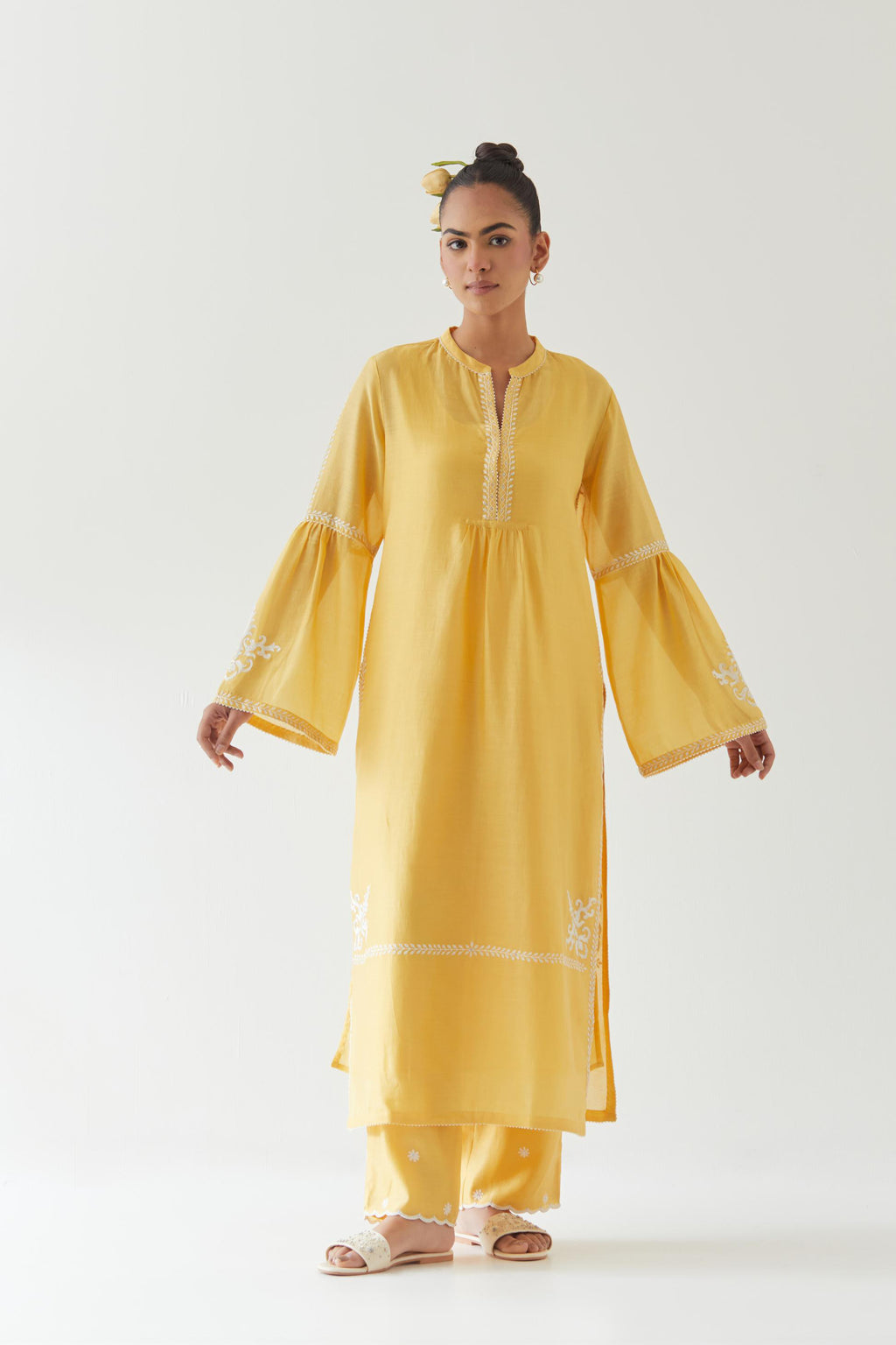 Yellow silk chanderi straight kurta set with long bell sleeves, highlighted with off white thread embroidery.