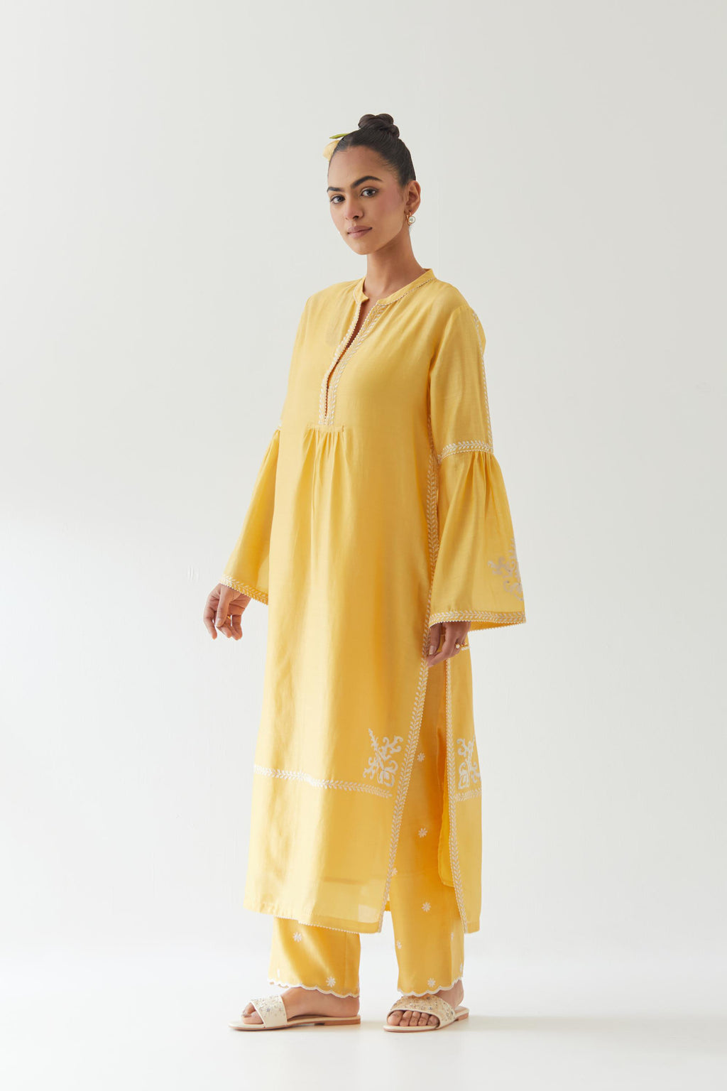 Yellow silk chanderi straight kurta set with long bell sleeves, highlighted with off white thread embroidery.