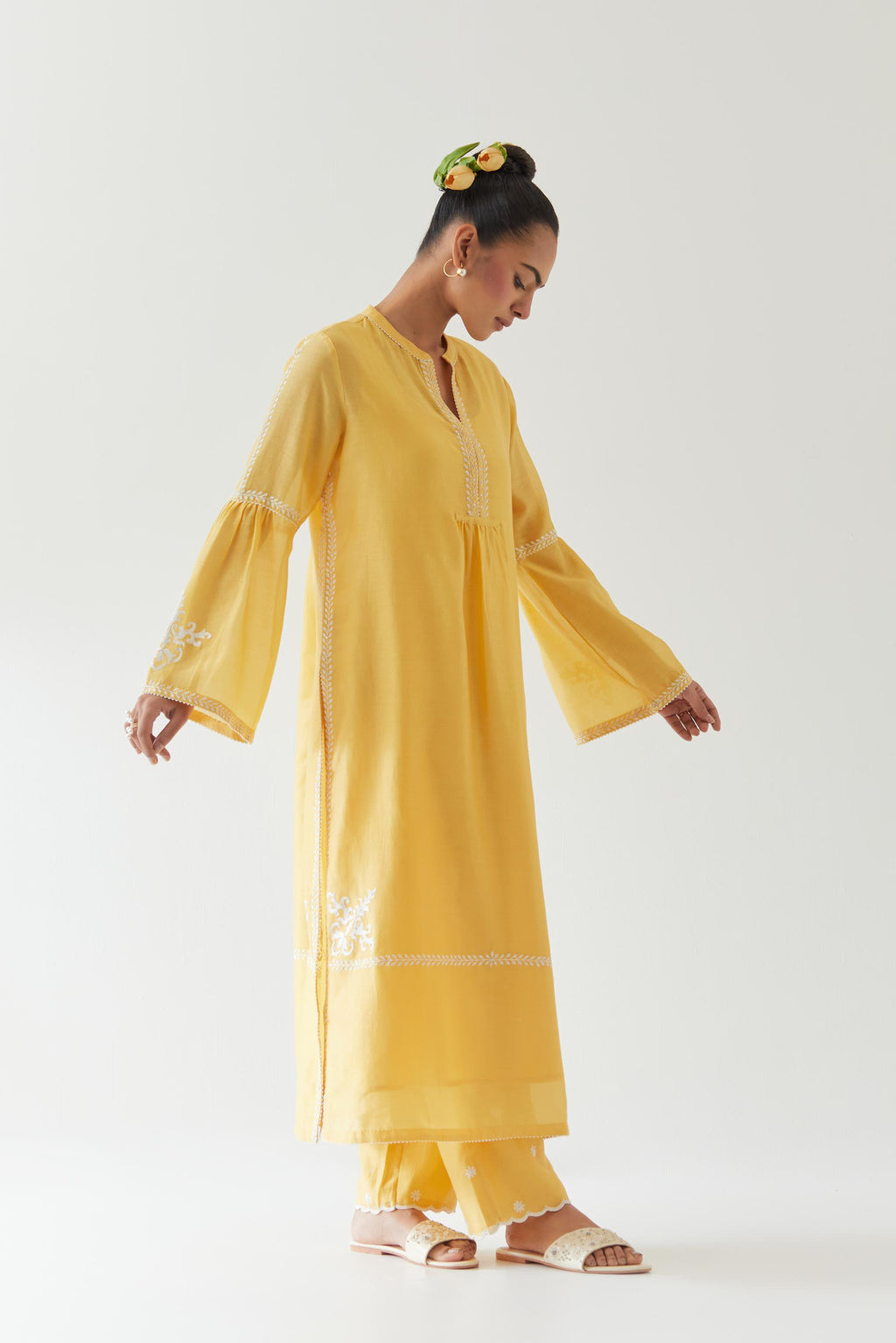 Yellow silk chanderi straight kurta set with long bell sleeves, highlighted with off white thread embroidery.