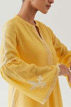 Yellow silk chanderi straight kurta set with long bell sleeves, highlighted with off white thread embroidery.