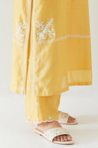 Yellow silk chanderi straight kurta set with long bell sleeves, highlighted with off white thread embroidery.