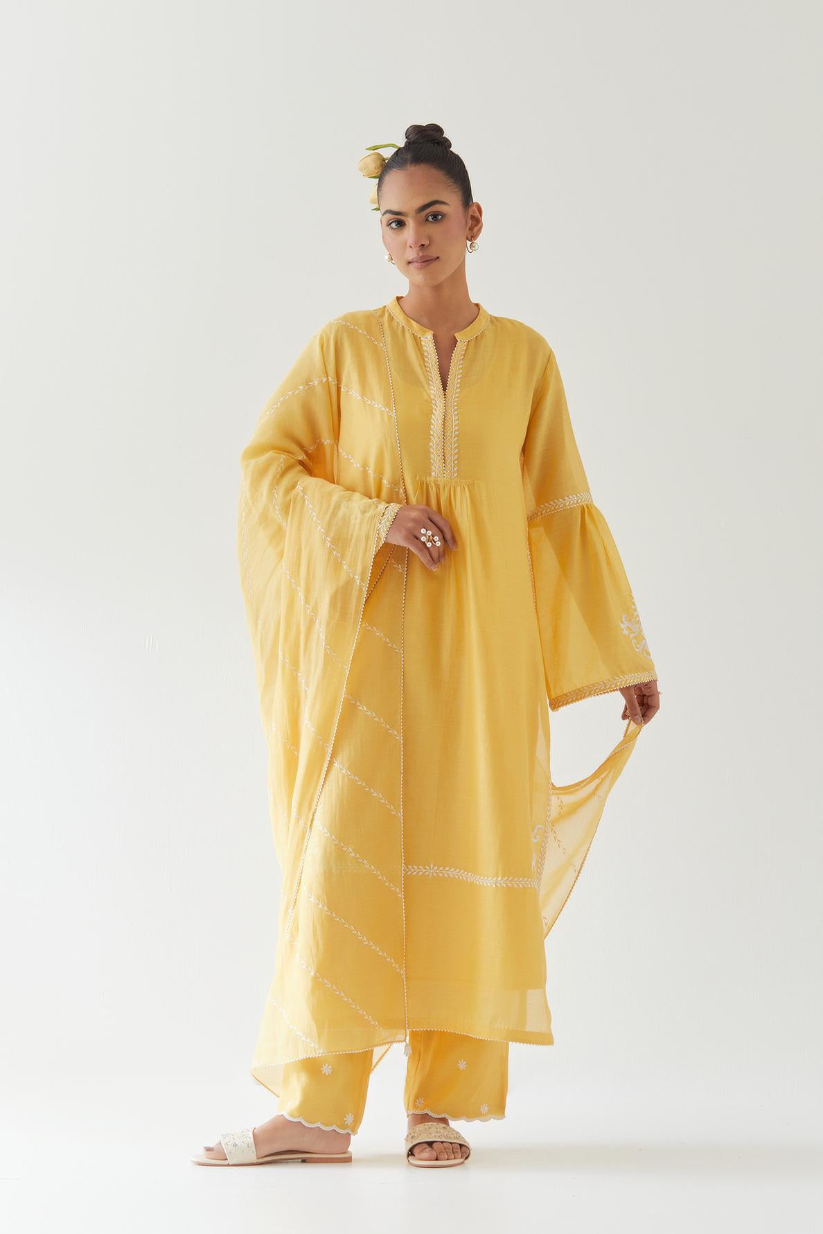 Yellow silk chanderi straight kurta set with long bell sleeves, highlighted with off white thread embroidery.