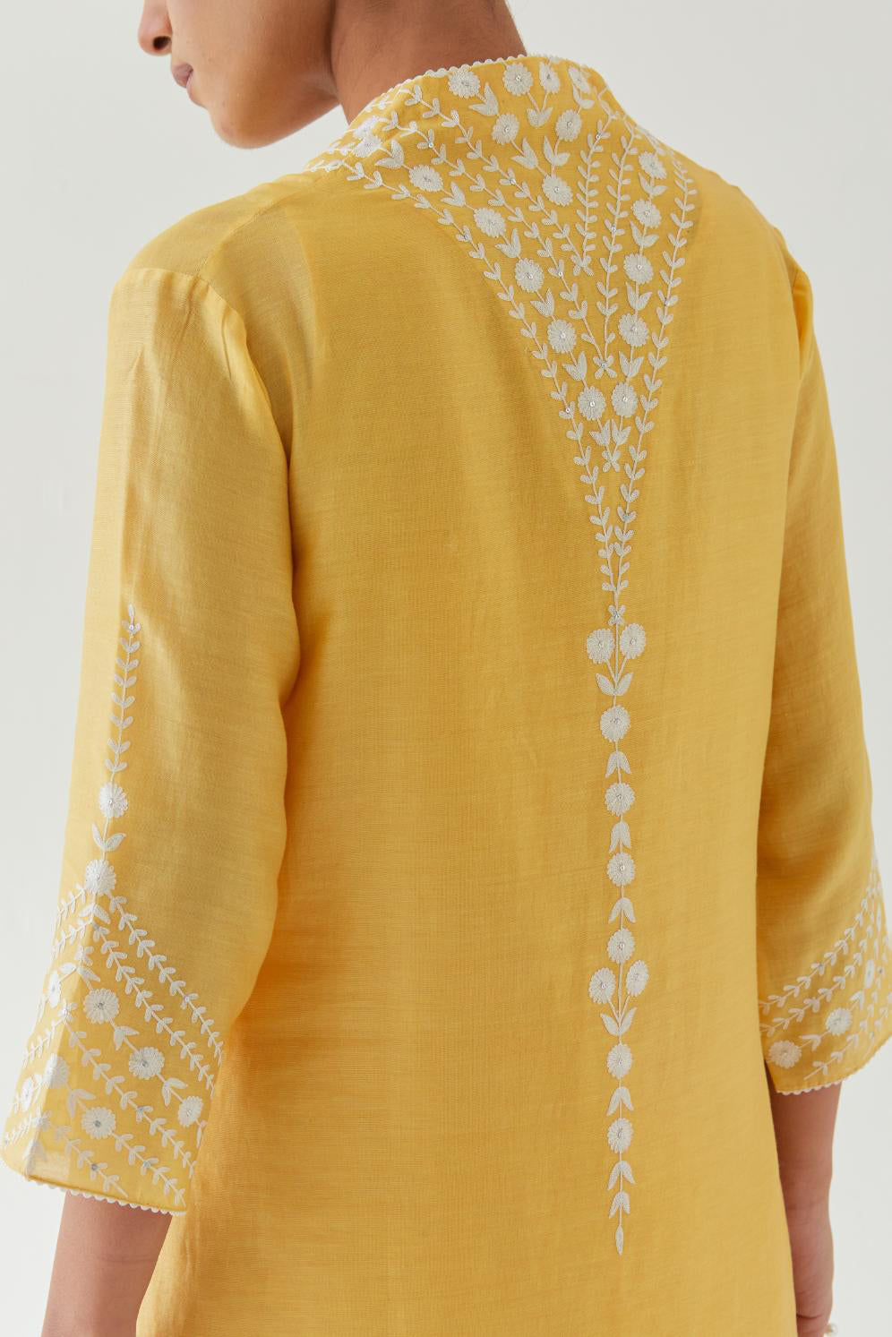 Yellow silk chanderi long straight kurta set highlighted with off white thread embroidery