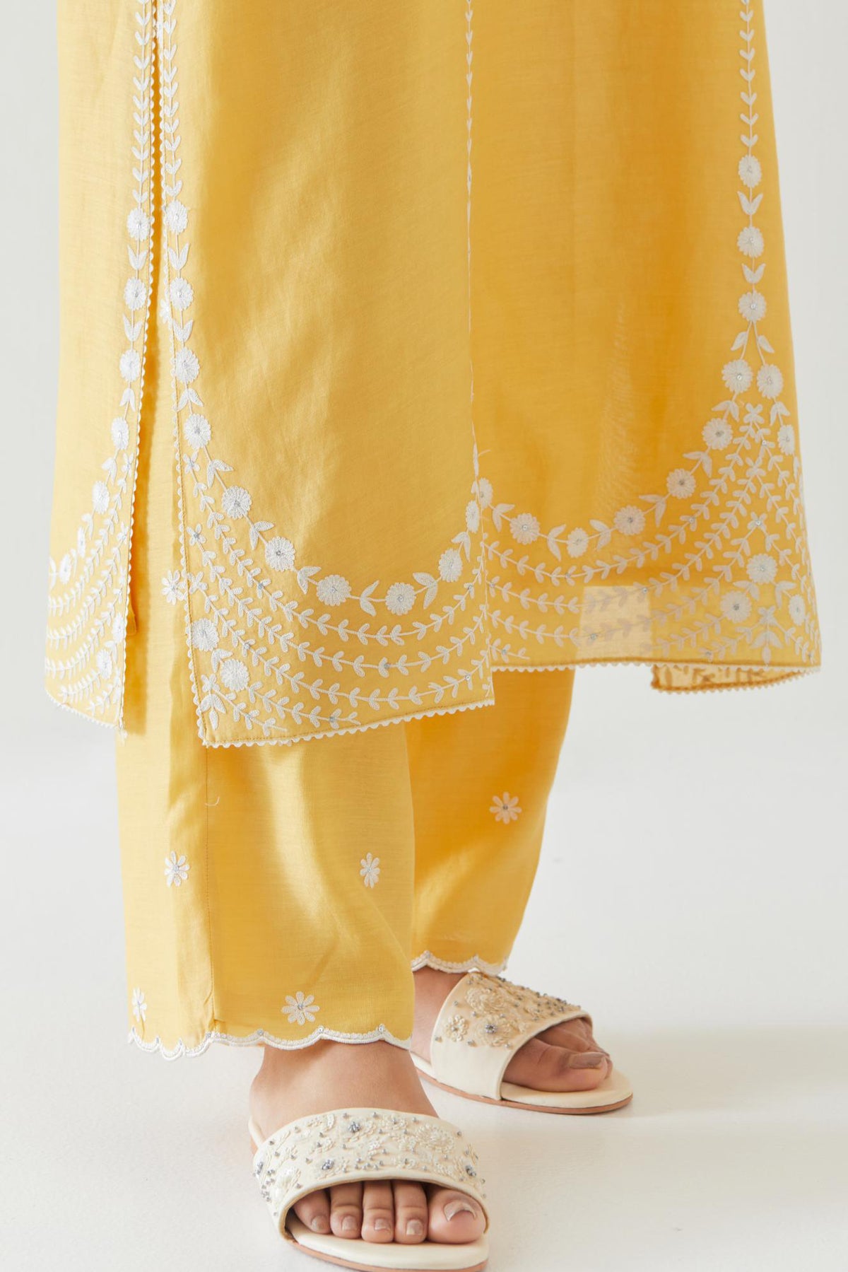 Yellow silk chanderi long straight kurta set highlighted with off white thread embroidery