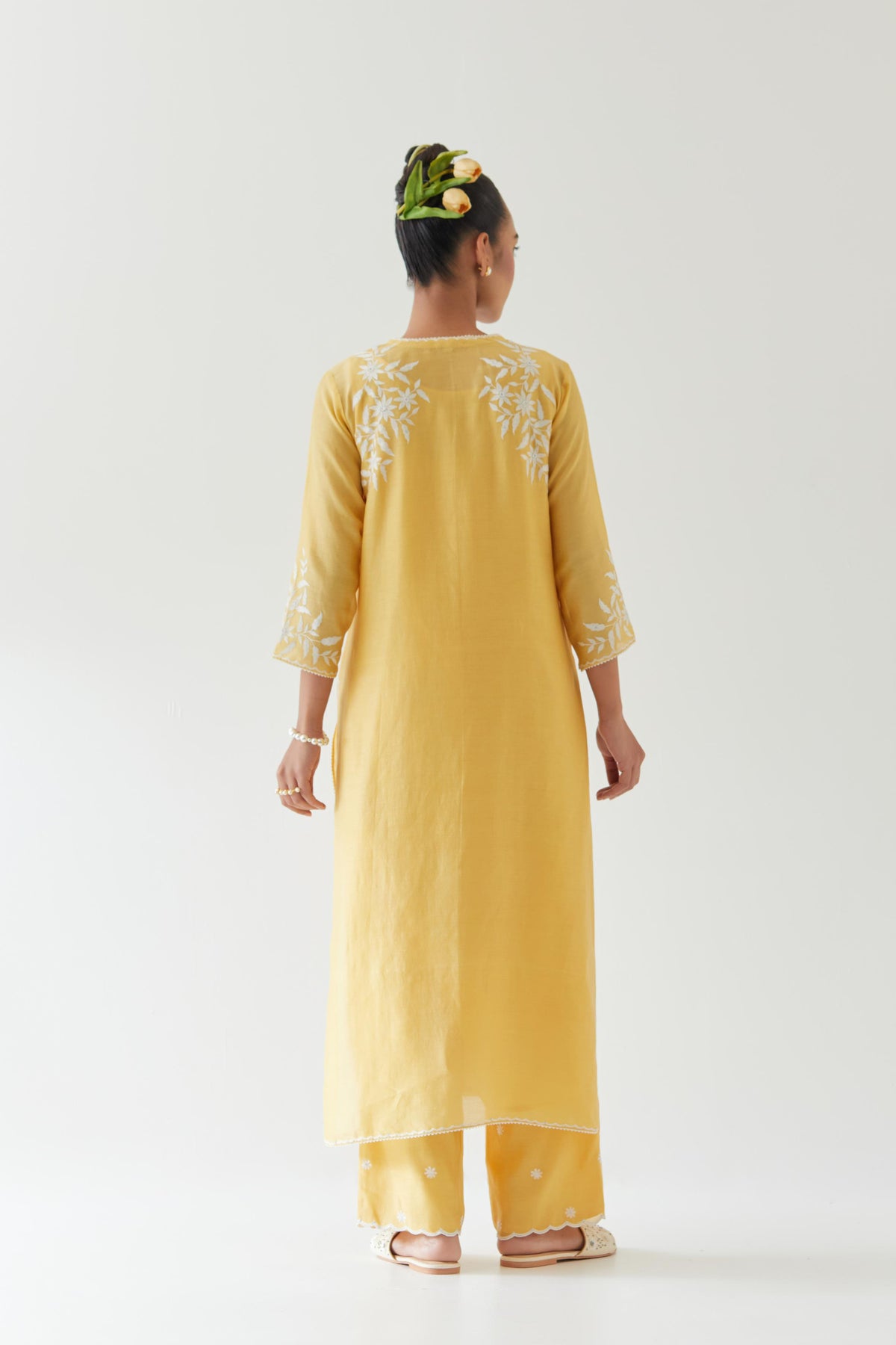 Yellow silk chanderi straight kurta set highlighted with off white thread embroidery.
