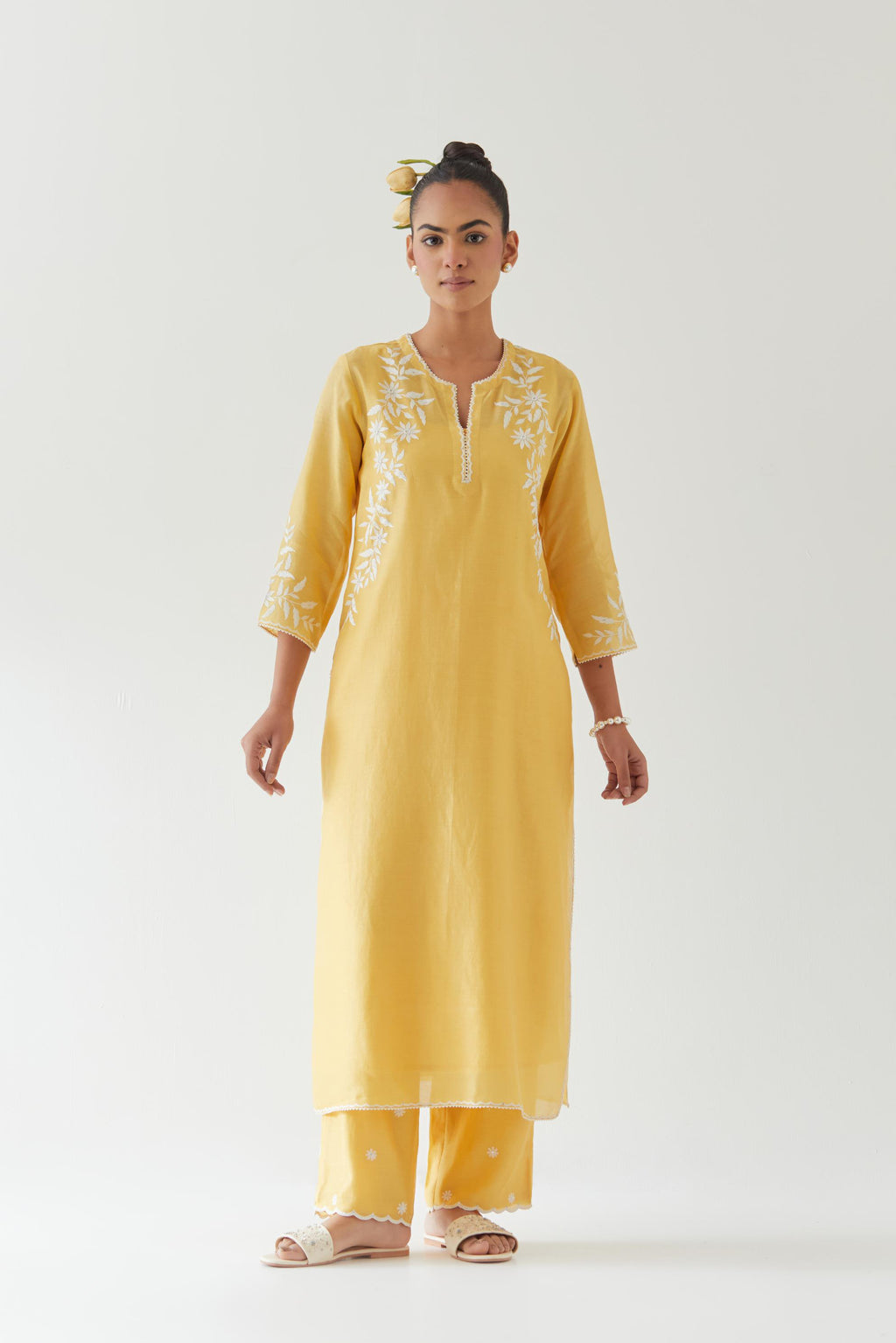 Yellow silk chanderi straight kurta set highlighted with off white thread embroidery.