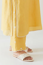 Yellow silk chanderi straight kurta set highlighted with off white thread embroidery.