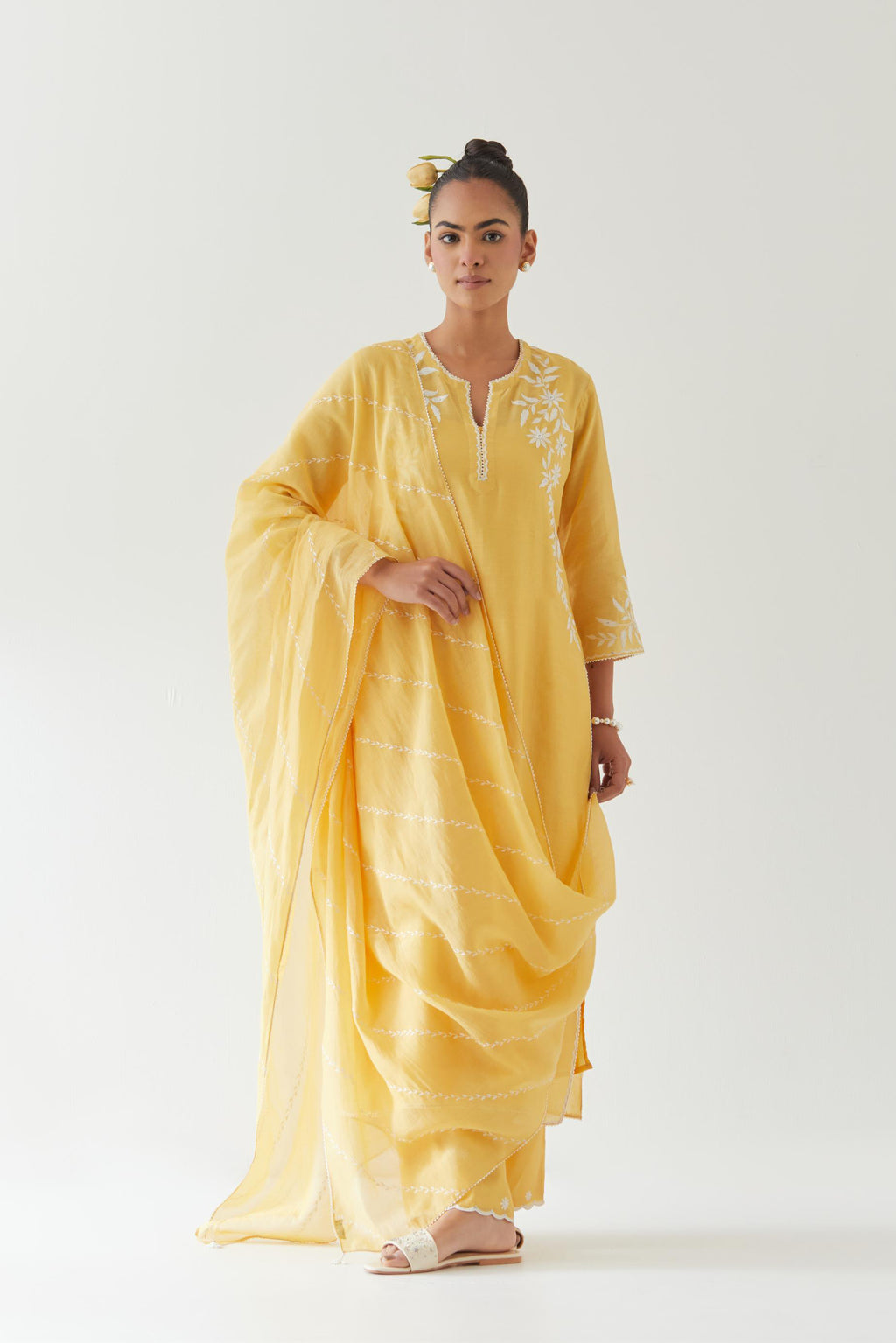 Yellow silk chanderi straight kurta set highlighted with off white thread embroidery.