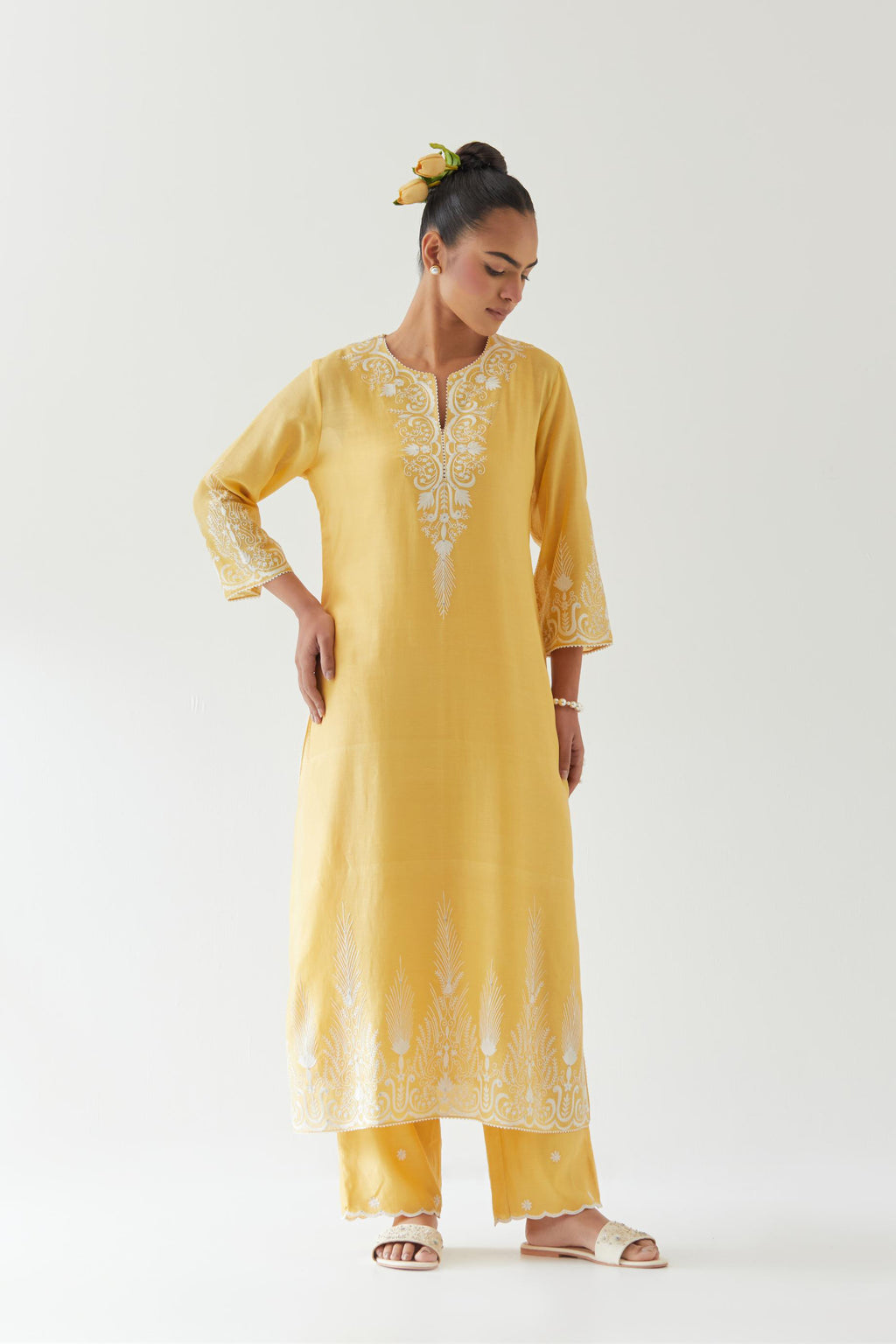 Yellow silk chanderi straight kurta set highlighted with off white thread embroidery.
