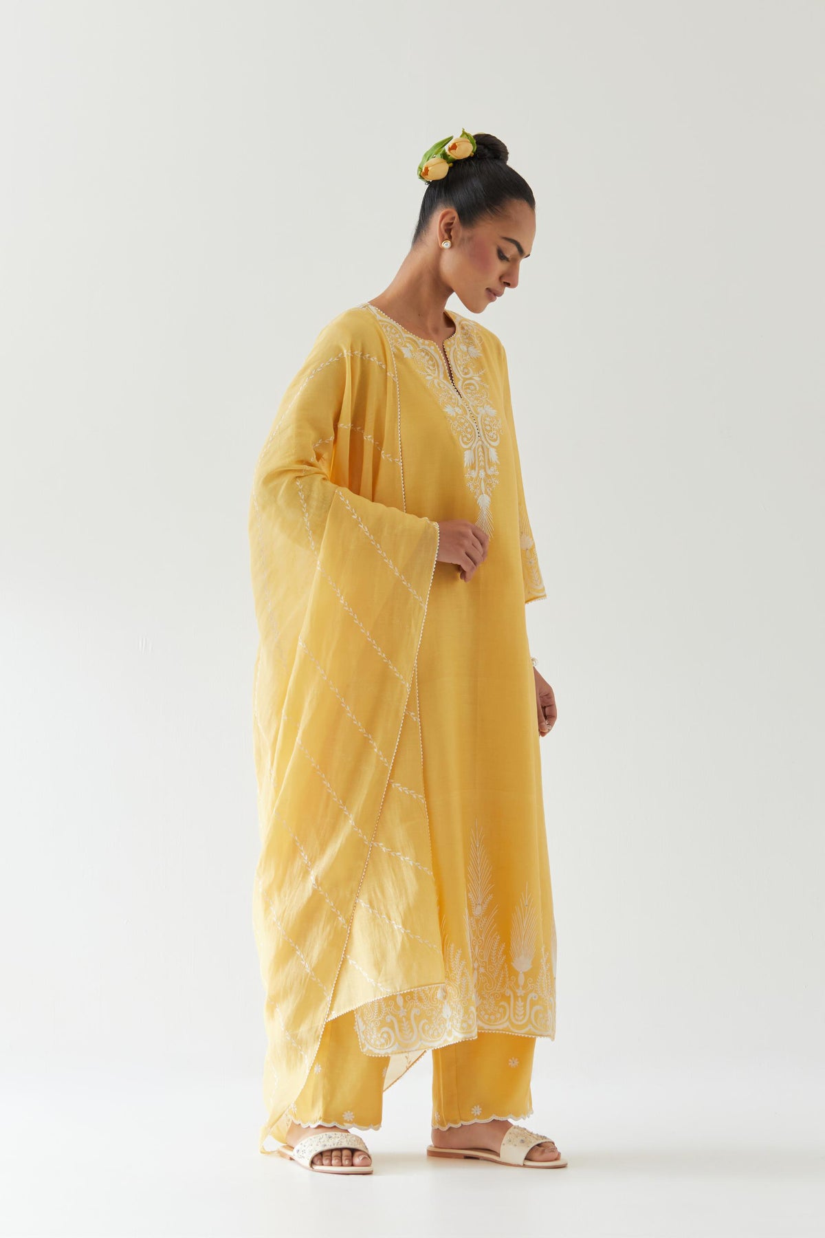 Yellow silk chanderi straight kurta set highlighted with off white thread embroidery.