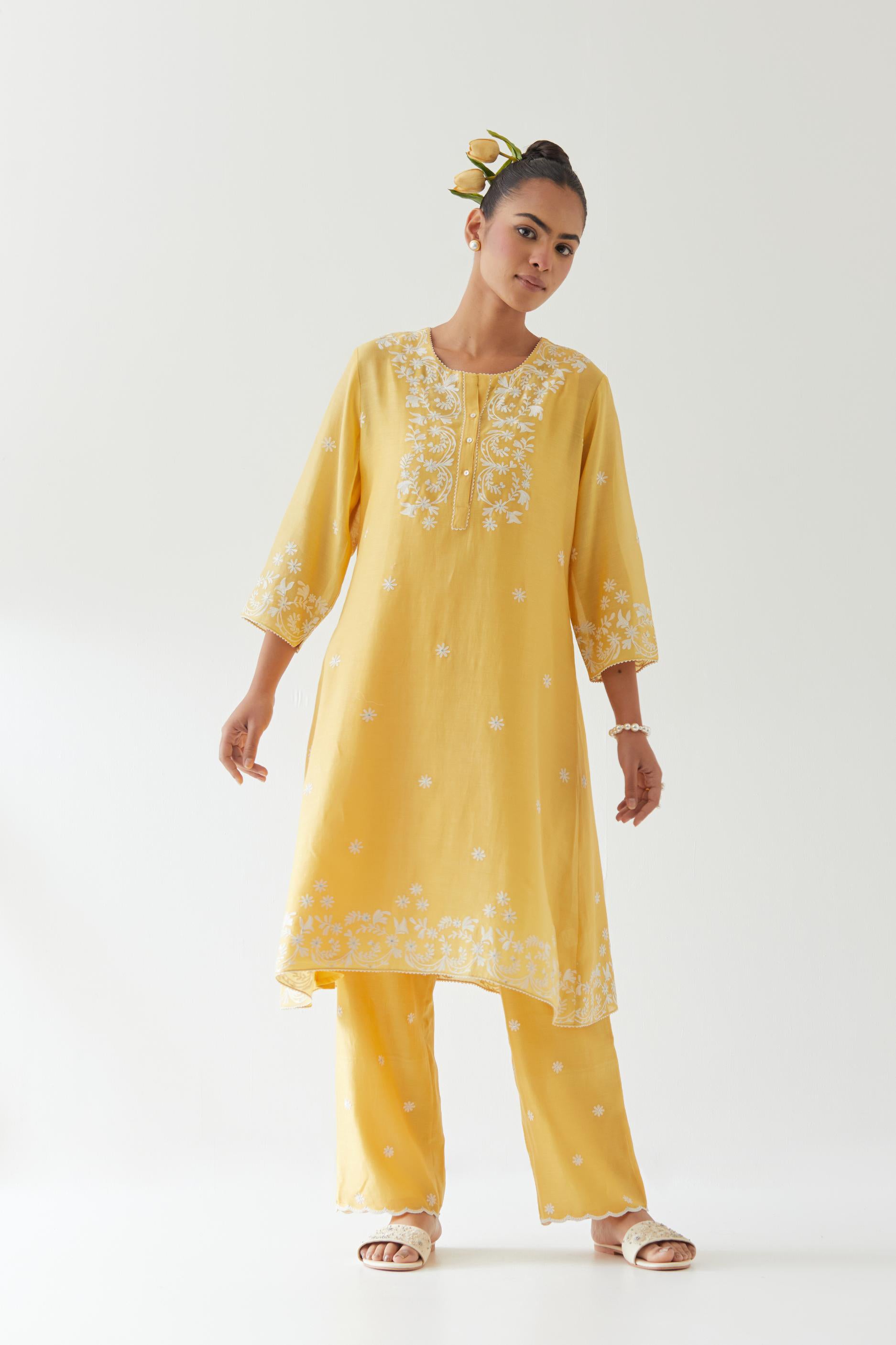 Yellow silk chanderi short A-line kurta set highlighted with off white thread embroidery.