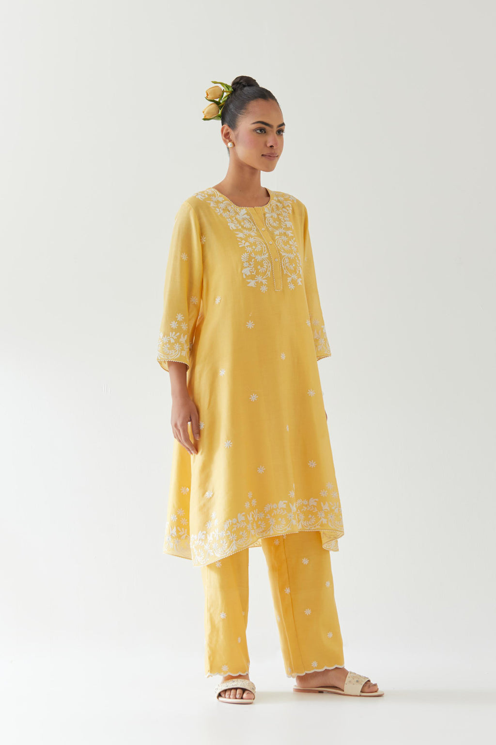 Yellow silk chanderi short A-line kurta set highlighted with off white thread embroidery.