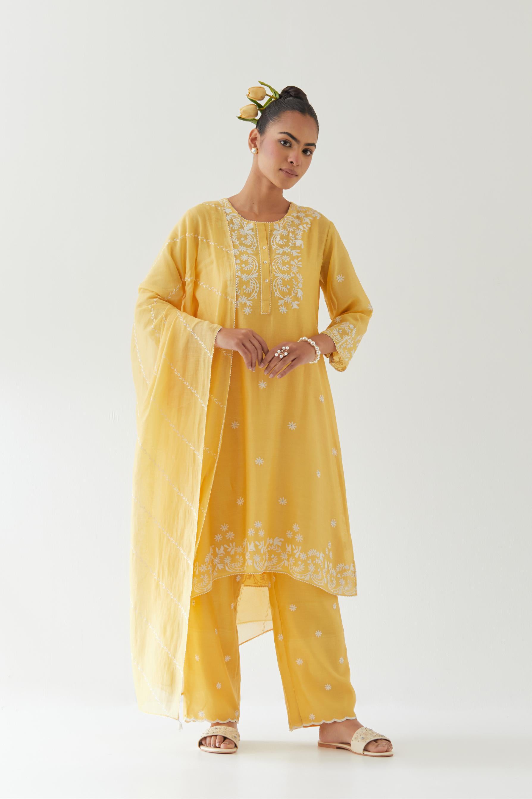Yellow silk chanderi short A-line kurta set highlighted with off white thread embroidery.
