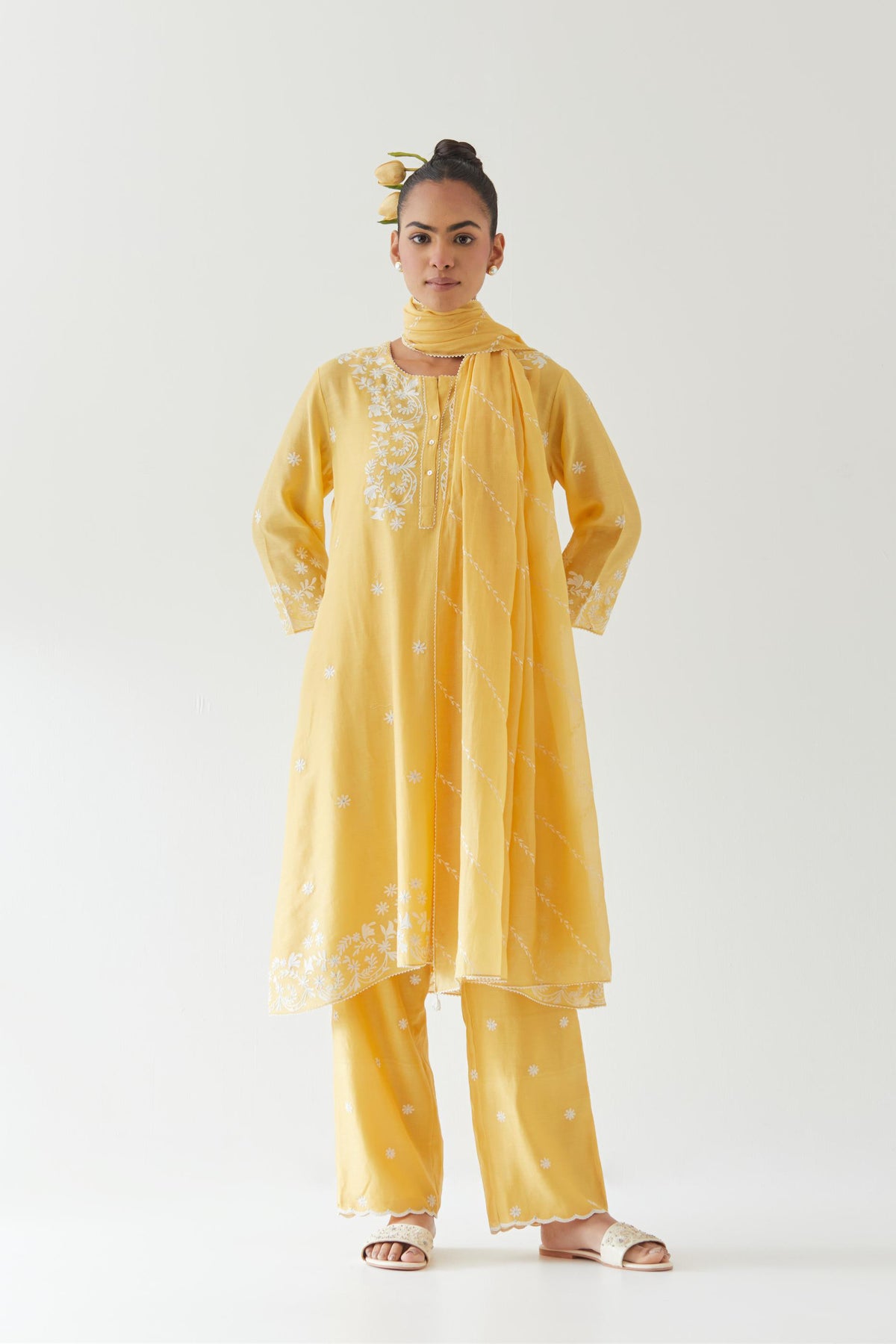 Yellow silk chanderi short A-line kurta set highlighted with off white thread embroidery.