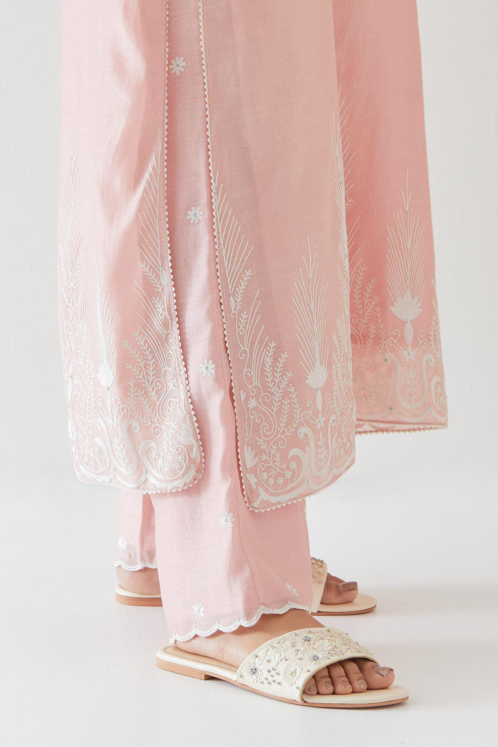 Pink silk chanderi straight kurta set highlighted with off white thread embroidery.