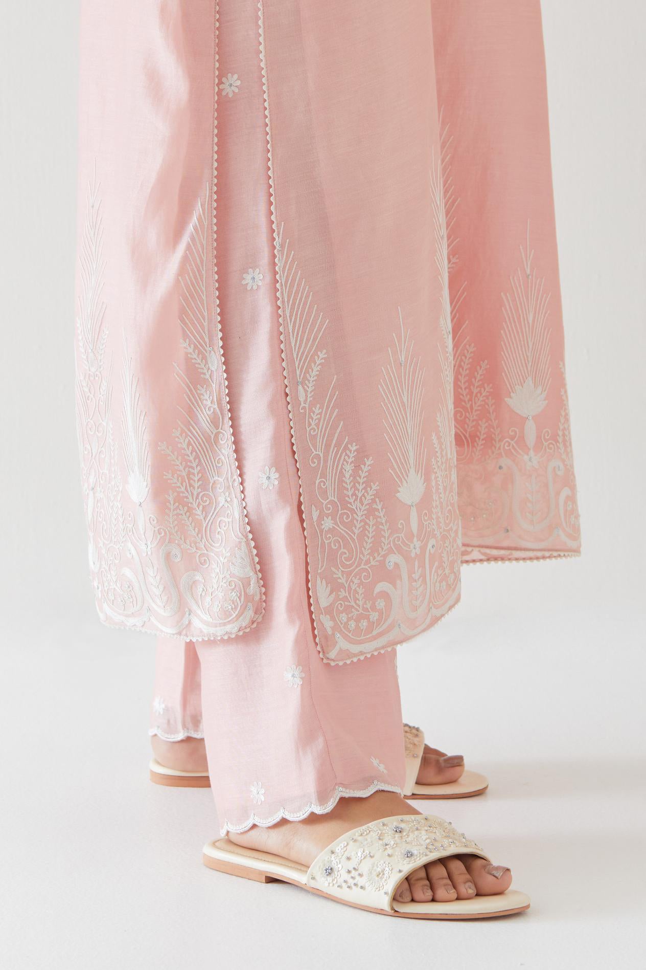 Pink silk chanderi straight kurta set highlighted with off white thread embroidery.