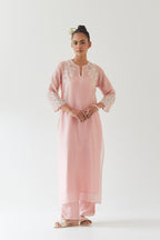 Pink silk chanderi straight kurta set highlighted with off white thread embroidery.