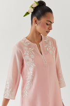 Pink silk chanderi straight kurta set highlighted with off white thread embroidery.