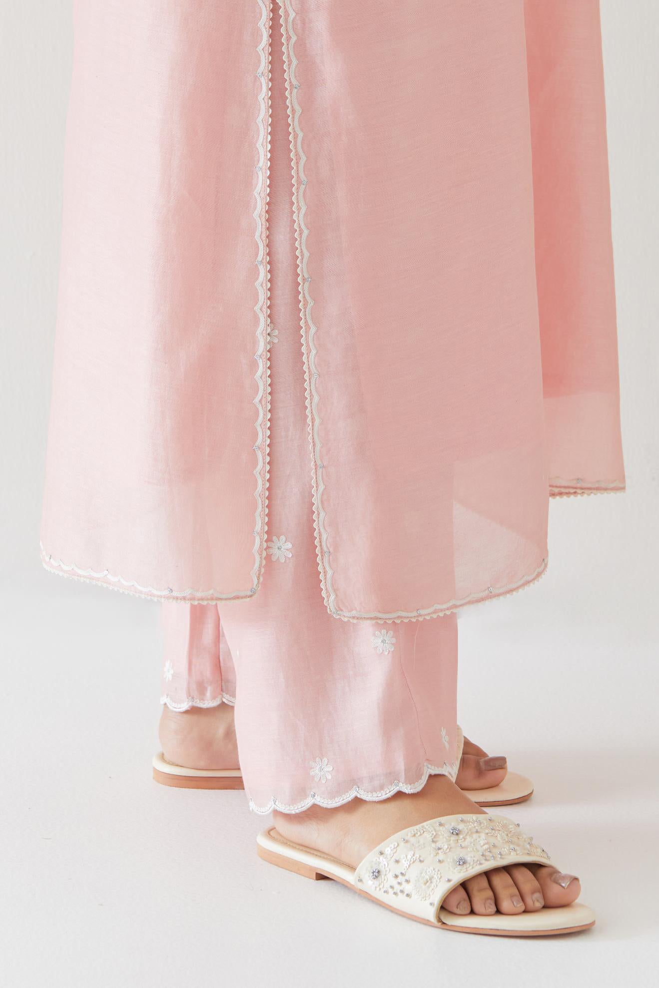 Pink silk chanderi straight kurta set highlighted with off white thread embroidery.