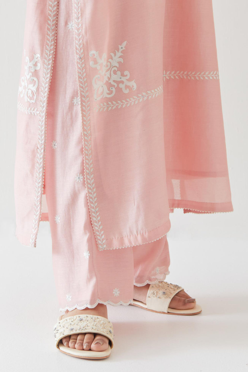 Pink silk chanderi straight kurta set with long bell sleeves, highlighted with off white thread embroidery.