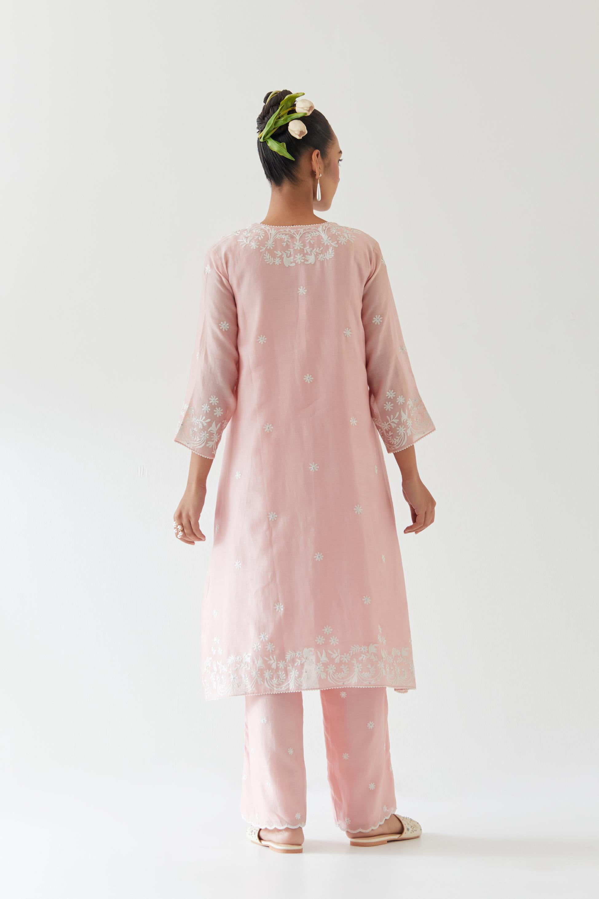 Pink silk chanderi short A-line kurta set highlighted with off white thread embroidery.