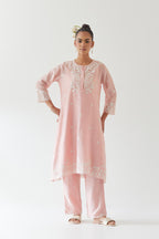 Pink silk chanderi short A-line kurta set highlighted with off white thread embroidery.