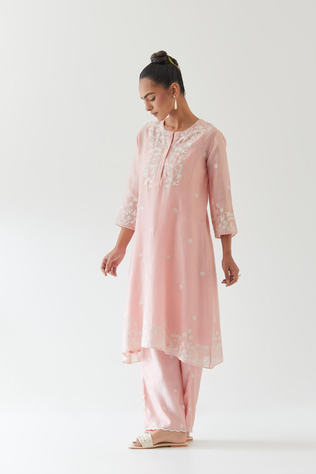 Pink silk chanderi short A-line kurta set highlighted with off white thread embroidery.