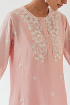 Pink silk chanderi short A-line kurta set highlighted with off white thread embroidery.