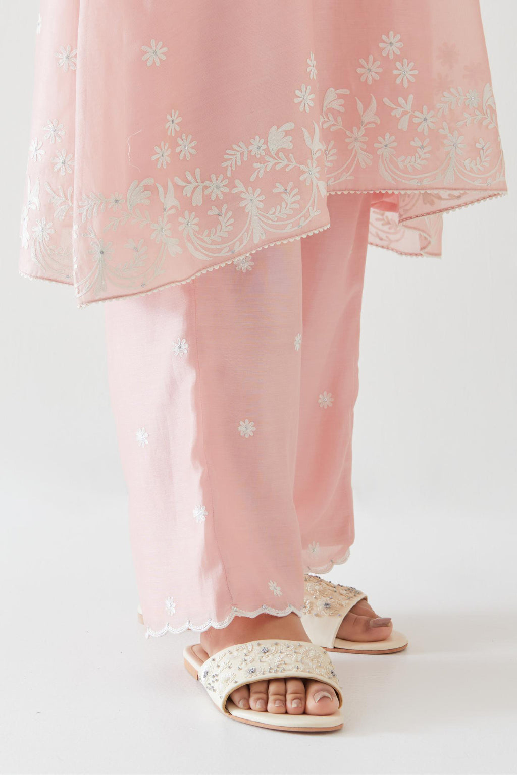 Pink silk chanderi short A-line kurta set highlighted with off white thread embroidery.